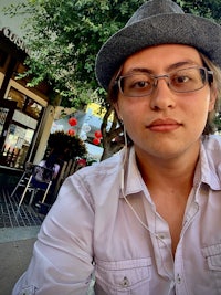 a man wearing a hat and earphones